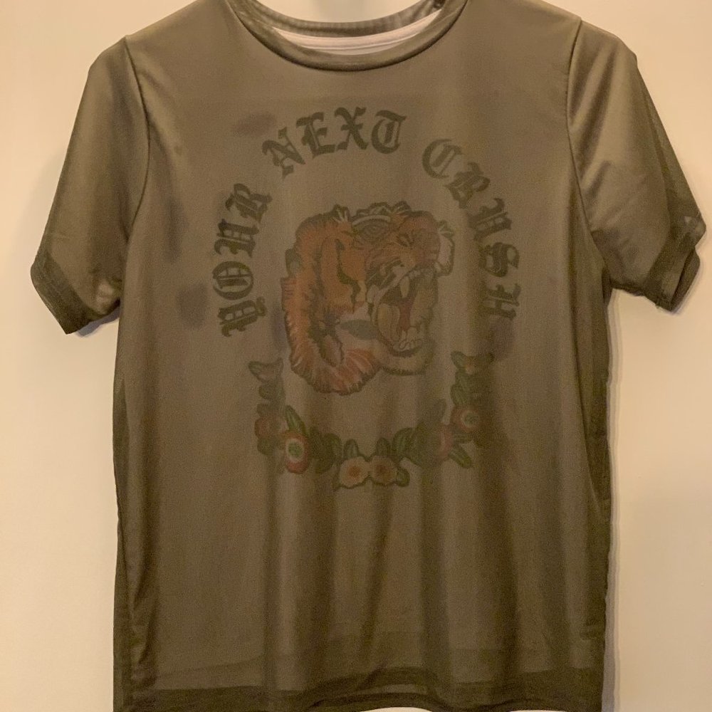 White t-shirt with green netting overtop.